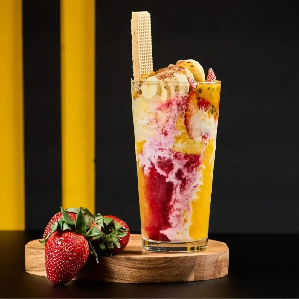 Colombian cholao with fruit, ice cream and a wafer served at Monchy's