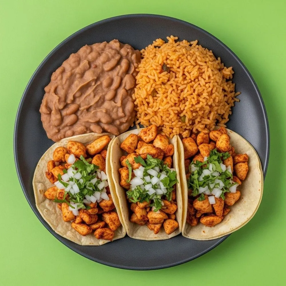 Three chicken tacos with cilantro and onion served with refried beans and Mexican rice