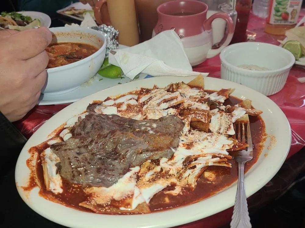Chilaquiles rojos with grilled steak and crema