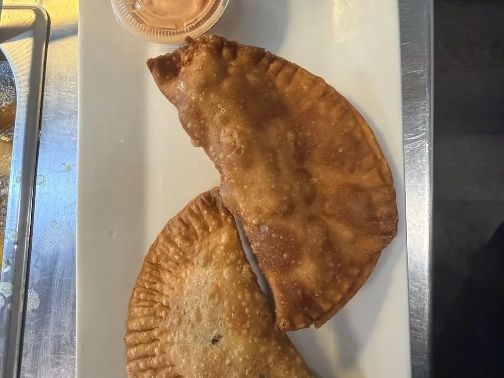 Golden empanadas with dipping sauce