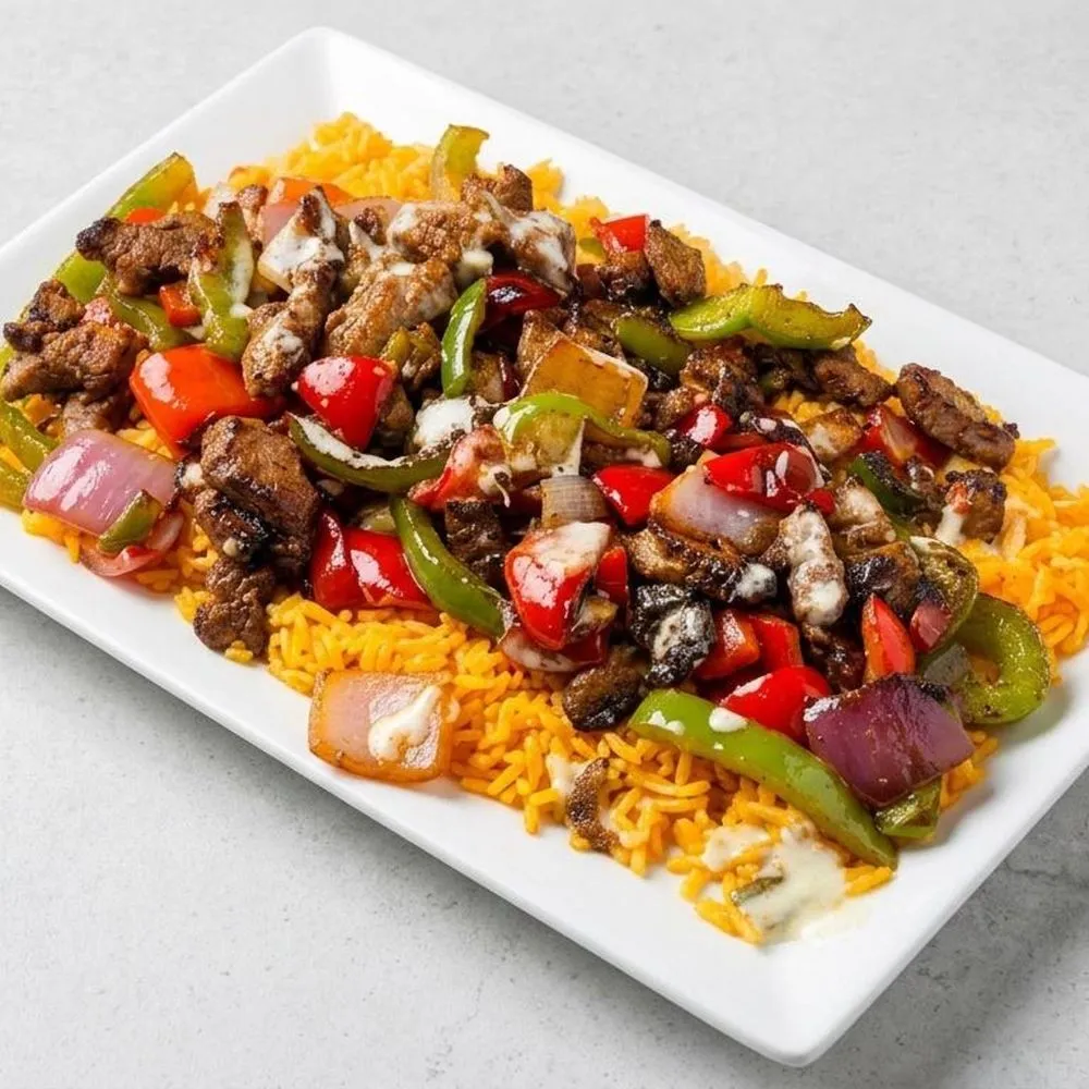 Carne asada with peppers and onions over Mexican rice