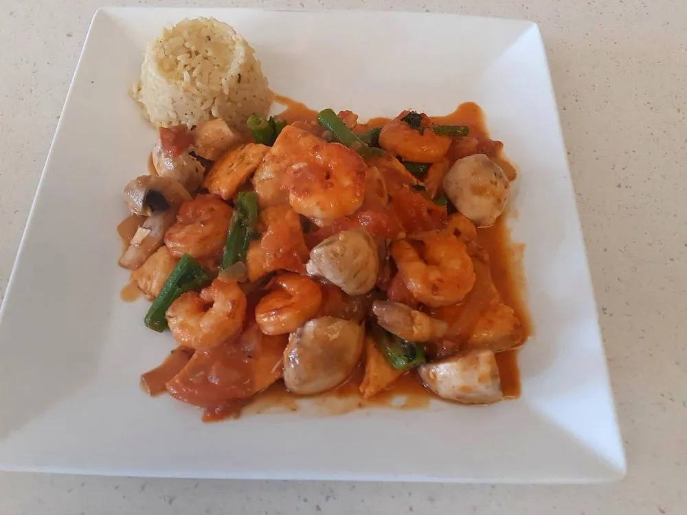 Chicken and shrimp with mushrooms in a red wine sauce with rice