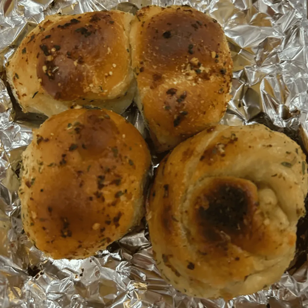 Garlic knots brushed with garlic butter and herbs