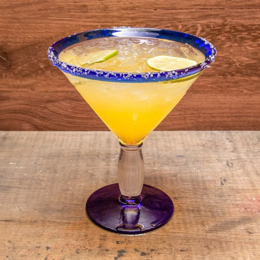 Mango margarita with a salted rim in a blue-rimmed glass