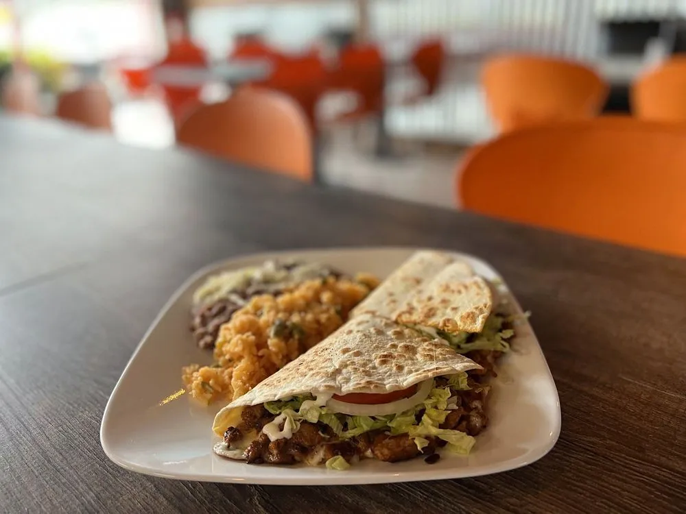 Quesadilla with rice and beans at a Super Tacos table