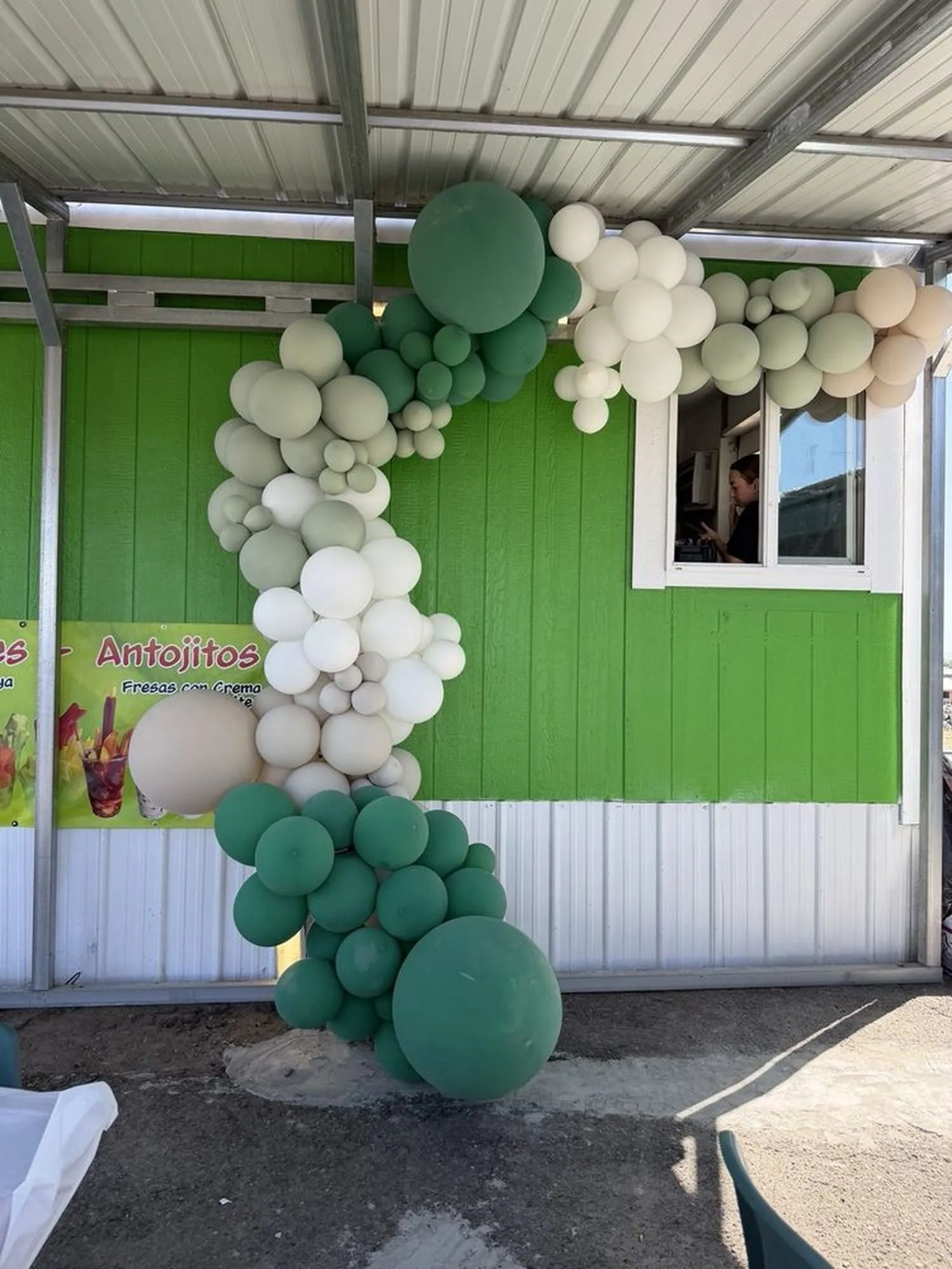 The bright green service window of the Coquitos Food truck