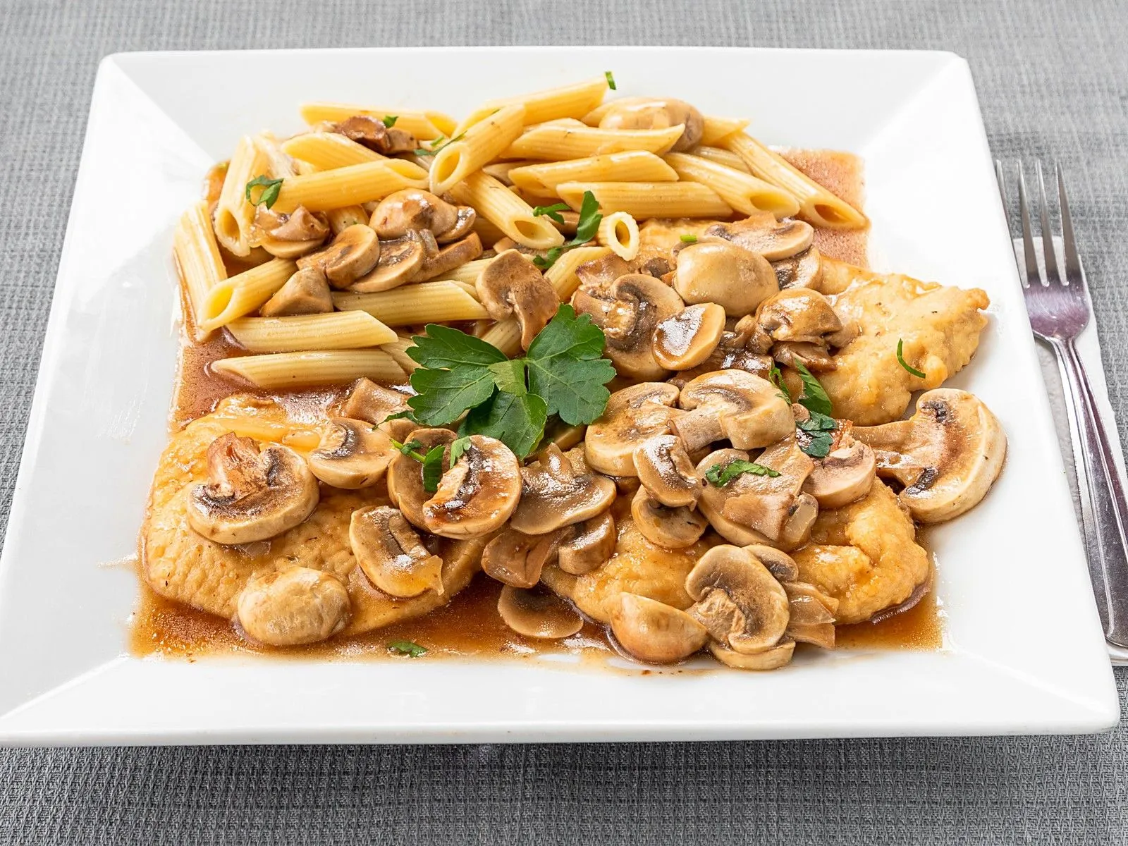 Chicken marsala with mushrooms over penne
