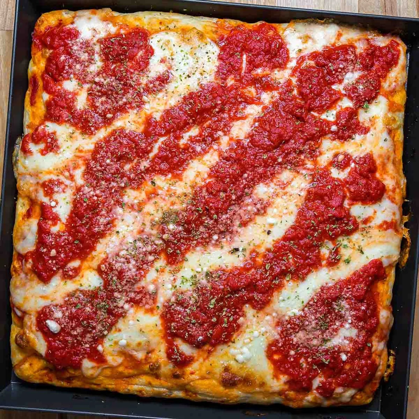 Square Sicilian pepperoni pizza fresh out of the brick oven