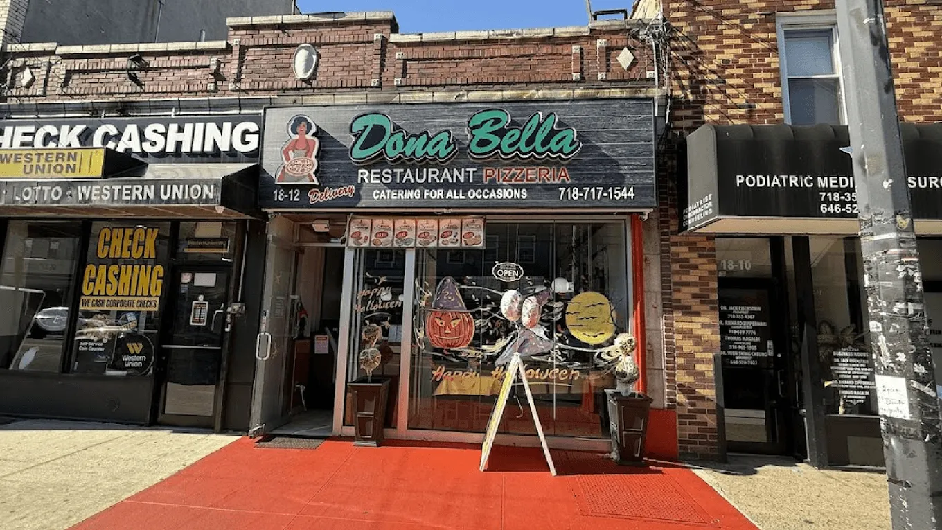 Donabella Restaurant Pizzeria storefront in Queens County with red entry carpet and glass doors